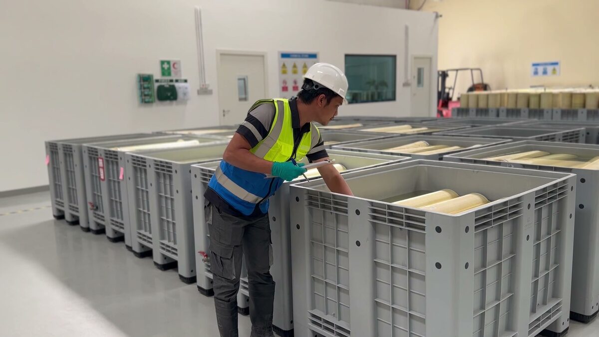 Operator in PPE checking elements in the intake crates